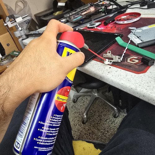 Putting wd 40 on a laptop hinge in order for the plastics to open more smoothly